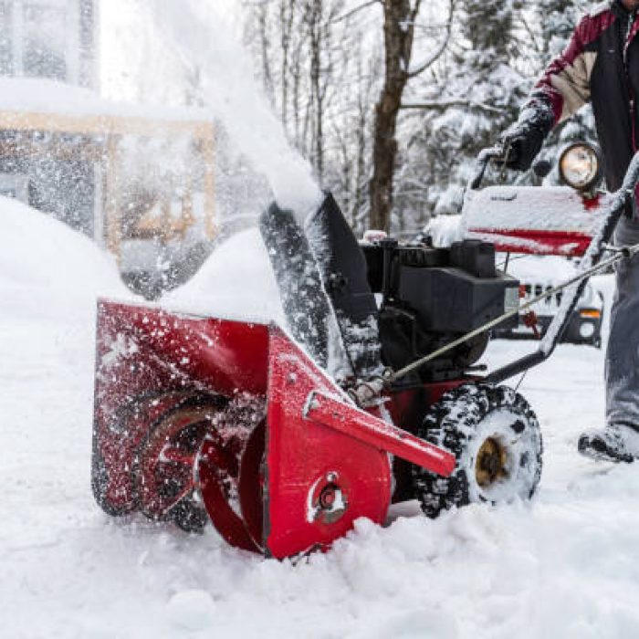 Senior Man Using SnowBlower After a Snowstorm, Quebec, Canada